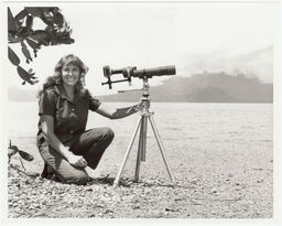 Anne LeBastille with a telescope and tripod mounted to her camera