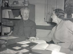 Man and woman sitting at desk in office