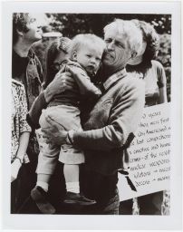 Philip Berrigan holding baby Freda at rally