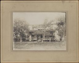 House with Woman Standing at Fence