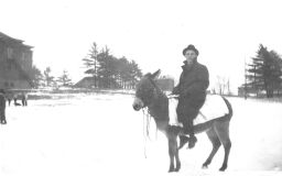 Hope College student riding a donkey