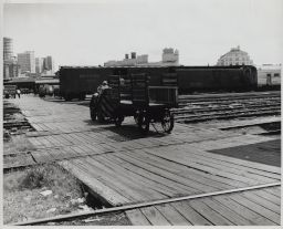 Express Tractors and Wagons Crossing Tracks