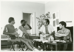 Four men sitting together