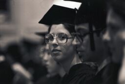 Young woman among classmates during Commencement