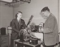 Prof. Lester F. Eastman and a Colleague Working With Apparatus and Meters