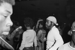 King dancing with an unidentified woman at Harlem World