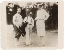 Two men golfing with African American caddy named Frank Ovary