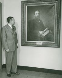 Deane W. Malott with portrait of Andrew Dickson White