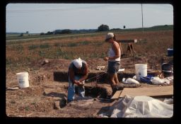 Archaeologists taking depth measurements during excavation of large outdoor firepit at the Townley-Read Site