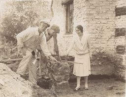 Olive Tjaden giving orders to workmen at her residence