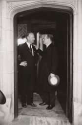 Perkins and Rockefeller standing in a doorway