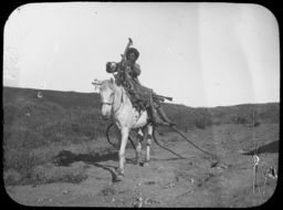 Young man on horseback with plow