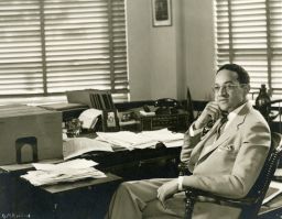 Raymond Pace Alexander (1897-1974), B.S. In Econ. 1920, at his desk in his law office, portrait photograph