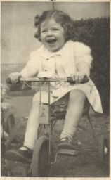 Photograph of Lindsay Cooper as a child on a tricycle