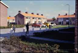 Children playing in the common areas between two-story attached residences (Druten, NL)