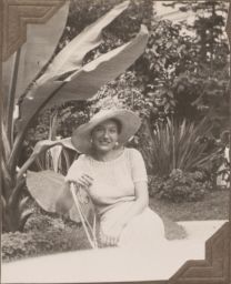 Janice Biala in hat sitting outside