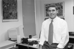 Daniel Crane, Agr., '98, at desk