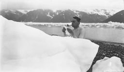 von Engeln in Alaska, smoking and reading notes behind iceberg (prints in box 4)