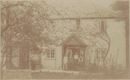 Photograph of Ford Madox Ford and Violet Hunt with three unidentified children at Knap Cottage, Selsey