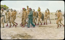 Group of men in loincloths, walking