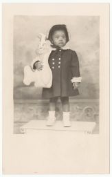 Young girl holding stuffed rabbit toy