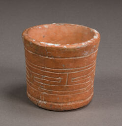 Small cup or cup-like vessel incised with detailing in interlocking spiral-fret and parallel band design