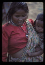 mahila sano nani pithayuma bokadai (महिला सानो नानी पिठ्युमा बोक्दै / Woman Carrying a Child in her arm)