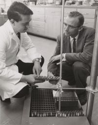 Photo of Robert Holley and John Penswick in Lab