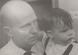 Photograph of Archie Ammons and toddler aboard a ship, ca. 1968.