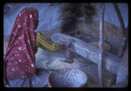 Dhikima makai kutdai gareko Mahila (ढिकीमा मकै कुट्दै गरेको महिला / Woman Grinding Corn in Grinder (Dhikki))
