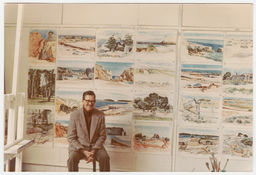 Kenneth Evett sitting in front of his paintings, #1