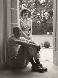 Phyllis (standing) and A.R. Ammons at open French door ca. 1980