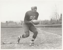 Jerome Holland, class of 1939, playing football.