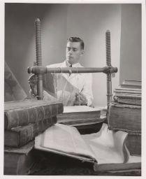 Photo of Max Adjarian, 23-yr old French bookbinder for Cornell University Library (vertical)