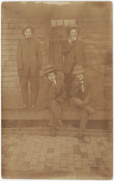 Male impersonators in suits on porch