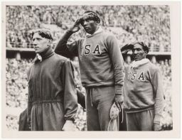 Jesse Owens, Ralph Metcalfe, and Tinus Osendarp on the podium for the 100 meter dash at the 1936 Summer Olympics