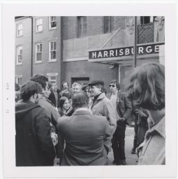 Daniel Berrigan outside and surrounded by people