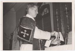 Philip Berrigan cleaning a cup at the altar