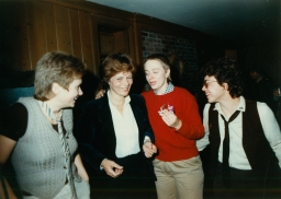 Four people talking at a party