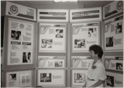 Woman in front of poster for Partners in Development