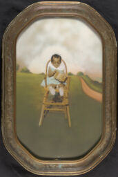 Child outdoors in a chair