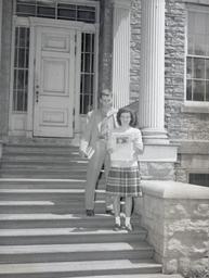 Students with newspaper at Main Hall east entrance