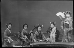 Several geishas pose with musical instruments