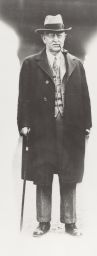 David Hoy with coat, hat, cane and pipe