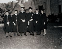 Six students stand outside on Commencement day