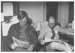 Two National Gay Task Force volunteers reading the newspaper