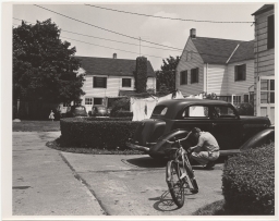 Photo of man working on his car in the service lane to houses in Burnham Place