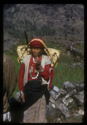 Pachadi Thunche boki ubhiyeko mahila (पछाडी थुन्चे बोकी उभिएकी महिला / Woman Standing by Carrying Thunche on Her Back)