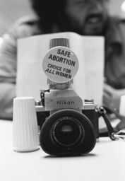 Camera with pro-choice button and salt and pepper shakers