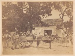 Men and women standing near wooden cart